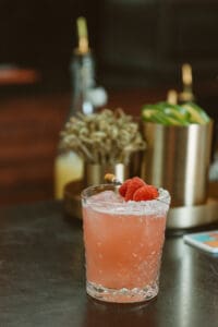 A drink with a strawberry garnish on top of it.