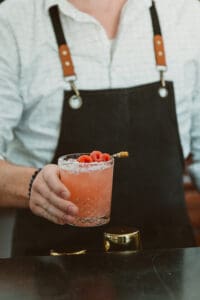 A person holding a drink in their hand.