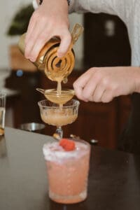 A person pouring liquid into a glass.