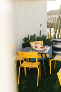 A table and chairs in the middle of an outdoor area.