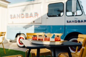 A table with some food on it and a truck in the background