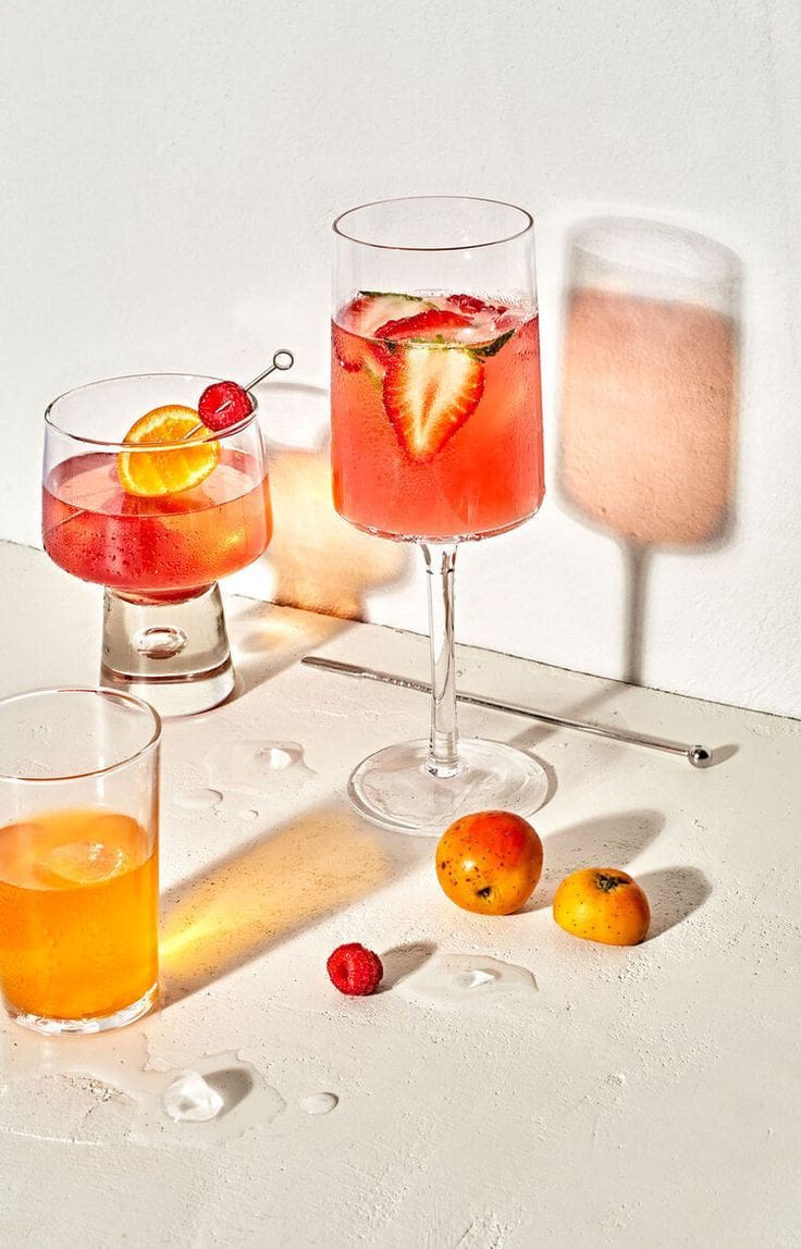 A table with several glasses of different drinks.