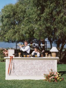 A man and woman standing at the top of a bar.