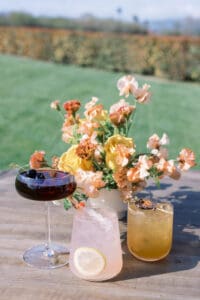 A table with two glasses and flowers on it