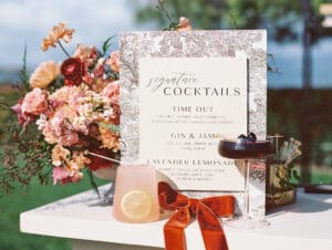 A table with a menu and a glass of lemonade.