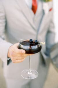 A person holding a glass of wine in their hand.